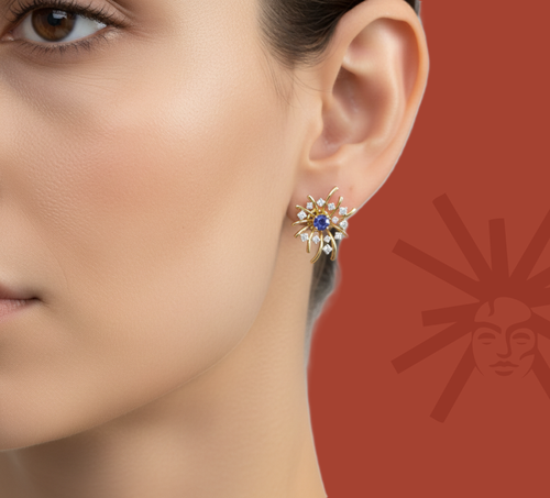 Starburst lab diamond earrings on ear in yellow gold vermeil with blue center stone