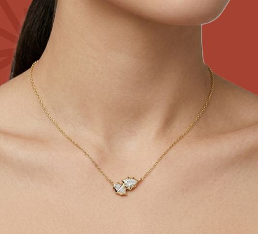 Two-stone diamond pendant necklace in gold vermeil on neckline close-up
