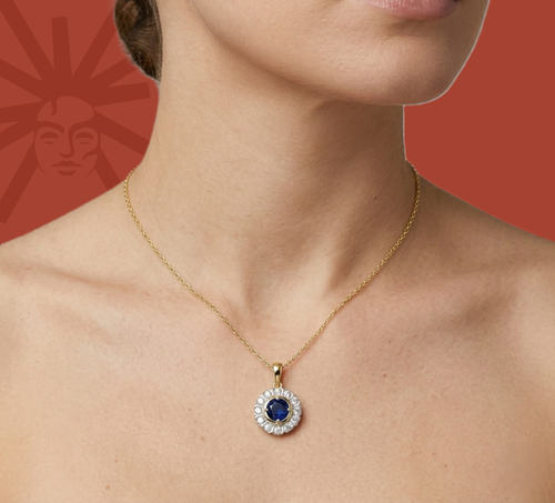 Diamond pendant on neck with blue center stone and white halo on yellow gold chain