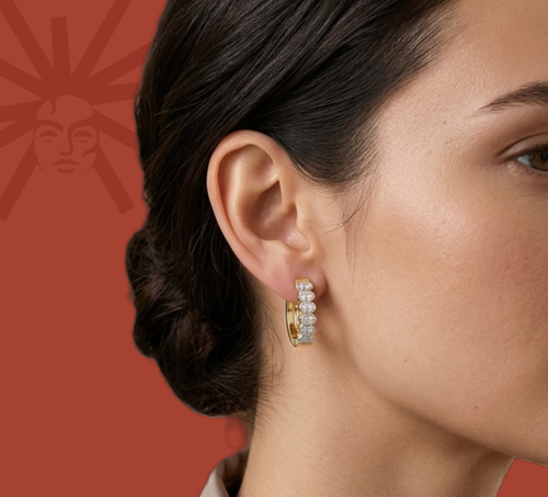 Model wearing yellow gold vermeil lab diamond hoop earrings with round stones