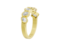 Gold ring with three diamond-like stones on a white background