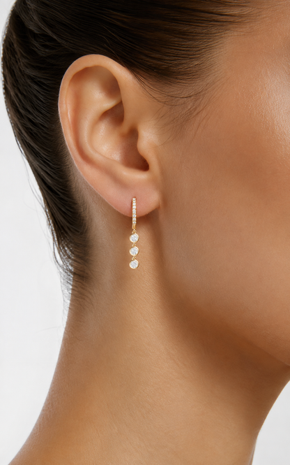 Small yellow gold vermeil hoop earrings with three round lab diamond drops on ear