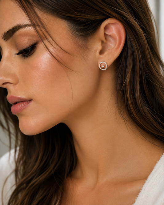 Round diamond stud earrings worn by model, yellow gold vermeil center with silver halo