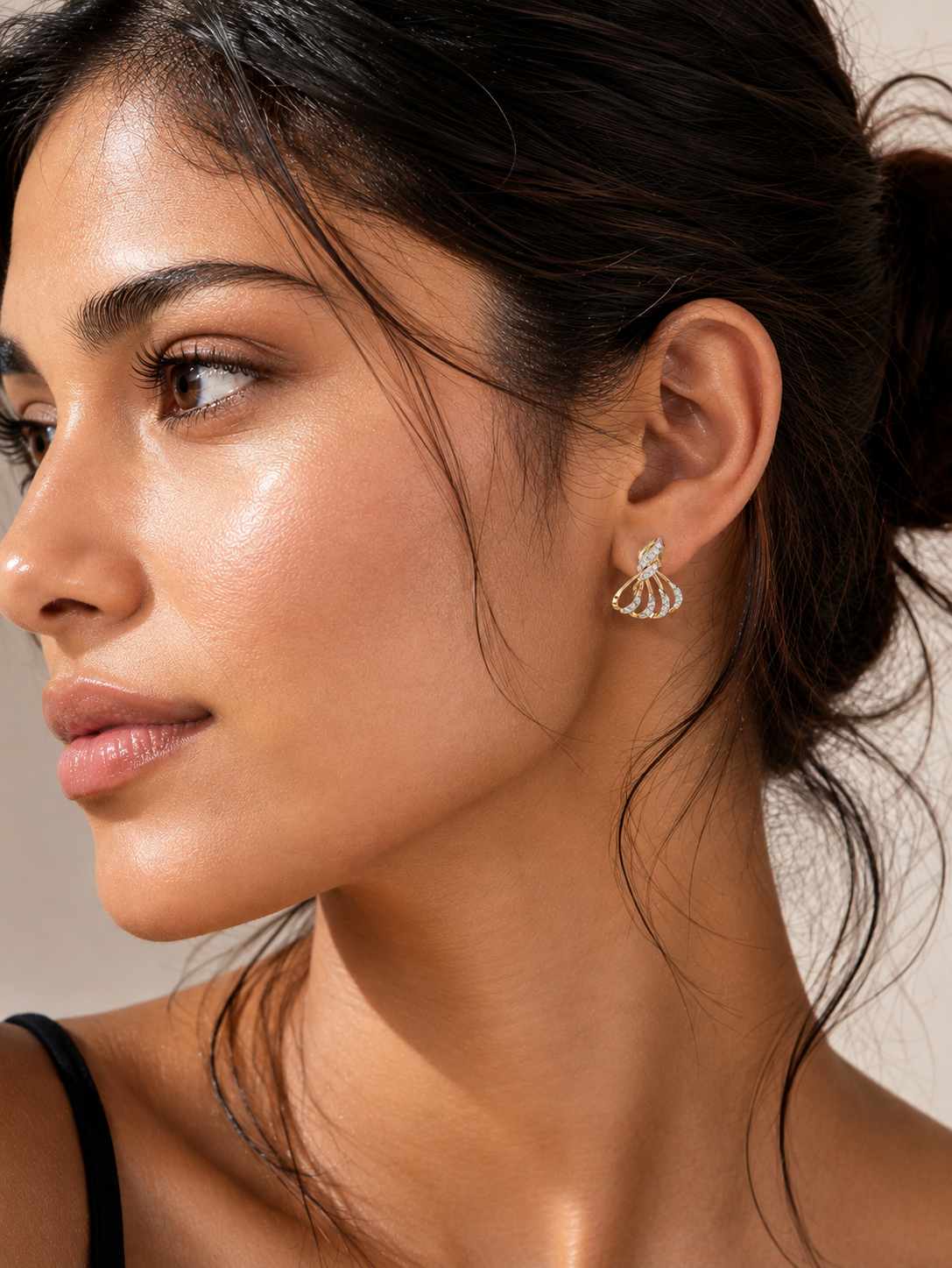 Woman wearing gold vermeil diamond fan drop earrings visible on her ear