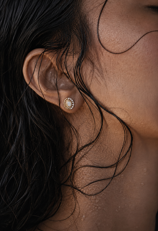 Model wearing yellow gold vermeil round diamond halo stud earrings