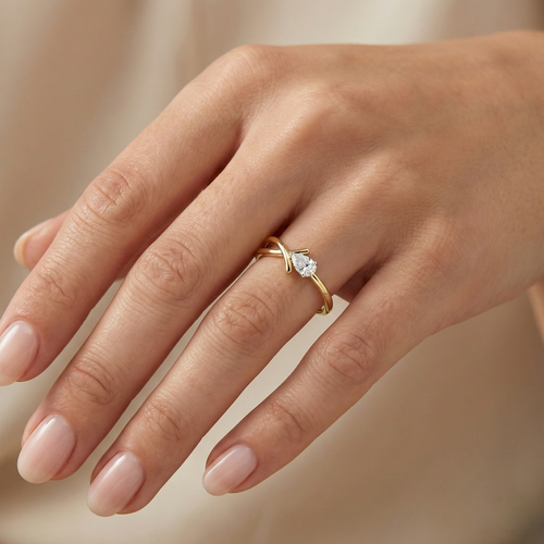 Yellow gold vermeil ring with round lab diamond on finger, crisscross band