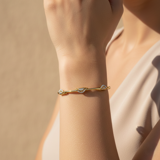 Yellow gold vermeil twist bangle with small lab diamond accents, on wrist