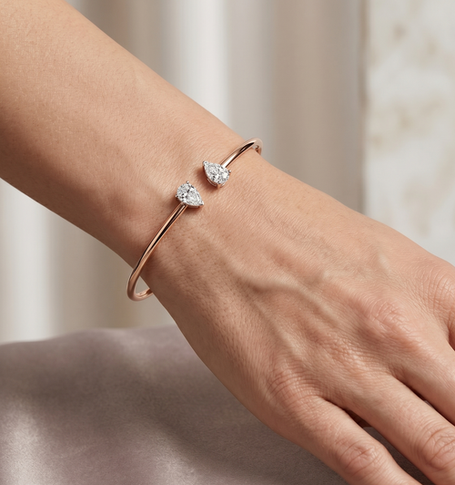Rose gold vermeil lab diamond cuff on wrist with two pear-shaped stones