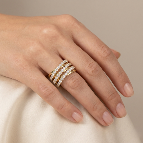 Gold diamond stack ring on hand, featuring stacked rows of round stones