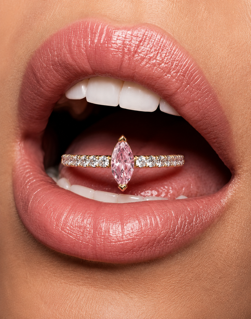 Lab diamond ring near lips: yellow gold vermeil band with pink marquise center